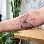 Estetyczny, nowoczesny tatuaż z motylem na przedramieniu